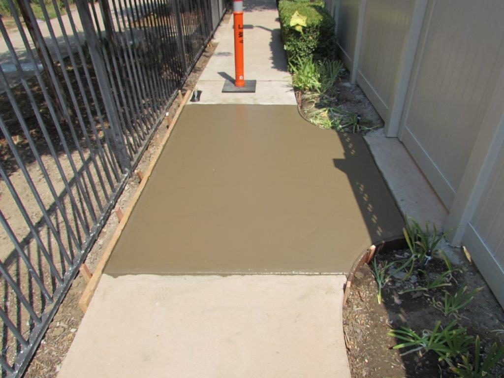 Newly placed concrete section between existing walkway panels